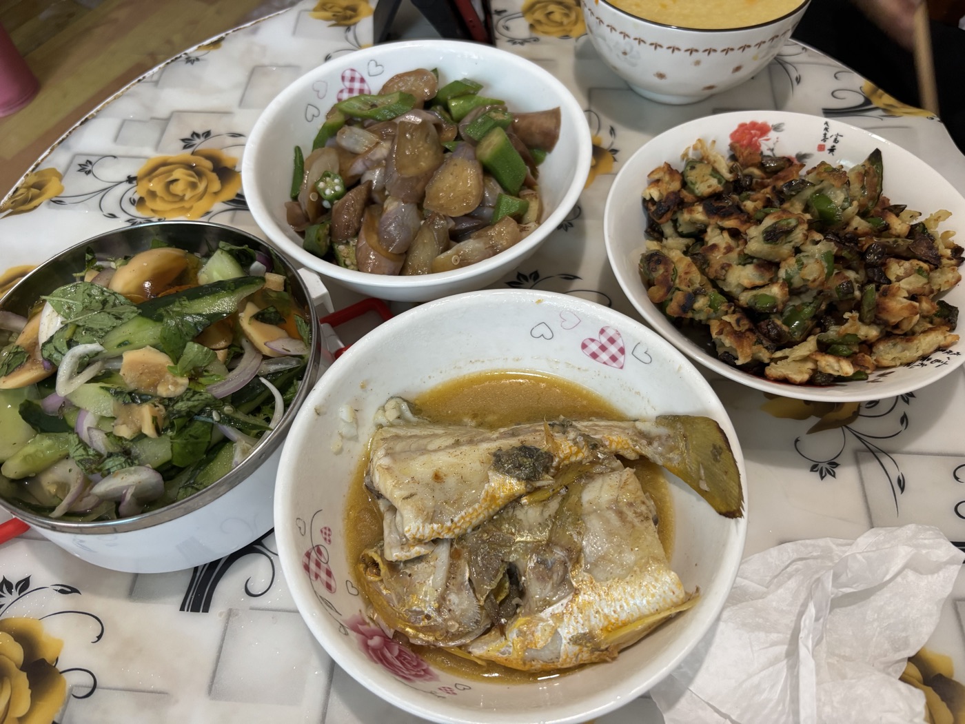 家里的饭桌，黄鱼、茄子炒辣椒、凉拌黄瓜和一碗玉米羹